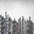 Old rusty drill bits of different sizes on grunge background