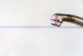 Old rusty drinking tap with a drop of water on a light background close-up. Royalty Free Stock Photo