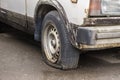 Old rusty and dusty car parked in the street Royalty Free Stock Photo