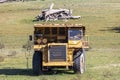 An old rusty earthmoving truck in a green field in regional Australia Royalty Free Stock Photo