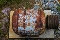 Old rusty engine parts surrounded by rocks and lush green grass and plants at Vickery Creek Royalty Free Stock Photo