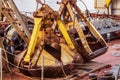 Old rusty excavator bucket lying on the deck of a river ship