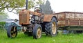 Old rusty farm tractor with trailer