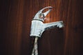 Old rusty faucet on wooden background