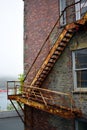 Rusty fire escape stairs on brick building Royalty Free Stock Photo