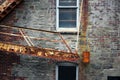 Vintage fire escape stairs with heavy weight on brick building Royalty Free Stock Photo