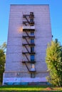 The old rusty fire escape to the floors is located near the wall of the building. House with metal staircase outside Royalty Free Stock Photo