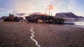 An old rusty fishing boat abandoned by a storm on the shore. Graveyard of ships, old fishing village on the shore of the Barents Royalty Free Stock Photo