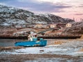 An old rusty fishing boat abandoned by a storm on the shore. Graveyard of ships, old fishing village on the shore of the Barents Royalty Free Stock Photo