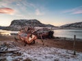An old rusty fishing boat abandoned by a storm on the shore. Graveyard of ships, old fishing village on the shore of the Barents Royalty Free Stock Photo