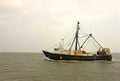 Old, rusty fishing trawler in early morning mist