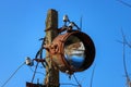Old rusty floodlight mounted on a support of electricity transmissions Royalty Free Stock Photo
