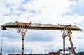 Old rusty gantry crane on blue sky background Royalty Free Stock Photo