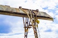 Old rusty gantry crane on blue sky background Royalty Free Stock Photo