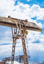 Old rusty gantry crane on blue sky background, vertical shot, outdoors Royalty Free Stock Photo