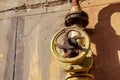 Old rusty gas control valve on the wall. An industrial valve in a large system. The gas transmission system of Ukraine is failing Royalty Free Stock Photo