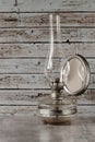 Old rusty gas lamp lit on vintage table Royalty Free Stock Photo