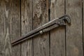 Old rusty gas wrench lies on a wooden table close up Royalty Free Stock Photo