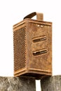 Old rusty grater on a white background