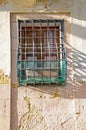 Old rusty grill fixed to a window in an old building in Valletta, Malta