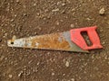 old and rusty hacksaw on the ground top view Royalty Free Stock Photo