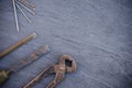 Old rusty hand carpentry tools and nails on a wooden table. Vintage pliers