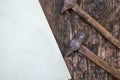 Old rusty hand tools. Two hammers and a sheet of paper on a crac Royalty Free Stock Photo