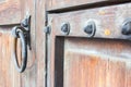 Old rusty handle on a wooden door Royalty Free Stock Photo