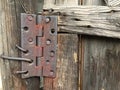 An old rusty hinge on a wooden door Royalty Free Stock Photo