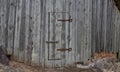 Old rusty hinge on a wooden door Royalty Free Stock Photo