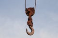 Old rusty hook of a hoisted crane in the port.