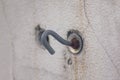 Old rusted hooks on white walls. Royalty Free Stock Photo