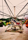 An old rusty horse carousel in an abandoned amusement Park .