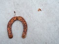 Old rusty horse shoe on a light color surface. Symbol on luck in a country setting. Rural theme Royalty Free Stock Photo