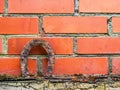 Old rusty horse shoe on a red color brick wall. Symbol on luck in a country setting. Rural theme Royalty Free Stock Photo