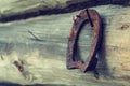 An old rusty horseshoe on an ancient wooden board. Royalty Free Stock Photo