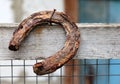 Old rusty horseshoe hanging on a nail