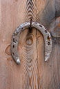 Old rusty horseshoe nailed to the door. The symbol of good luck. Amulet for happiness