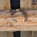 An old rusty horseshoe nailed to happiness under the roof of the house.