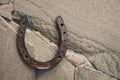 Old rusty horseshoe on natural stone background. Royalty Free Stock Photo