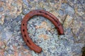 Old rusty horseshoe on stone