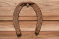 Old rusty horseshoe on vintage wooden board Royalty Free Stock Photo