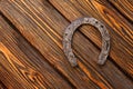 Old rusty horseshoe on vintage wooden board Royalty Free Stock Photo