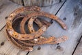 Old rusty horseshoe on a wooden background. Good luck symbol. Vintage concept. Royalty Free Stock Photo