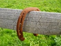 Old rusty horseshoe on wooden fence