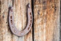 Old rusty horseshoe on wooden natural background. Symbol of luck Royalty Free Stock Photo