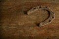 An old rusty horseshoe on a wooden table Royalty Free Stock Photo