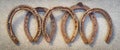 Old rusty horseshoes on a grey stone background. Good luck symbol. Vintage concept. Royalty Free Stock Photo