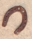 Old rusty horseshoes on sand