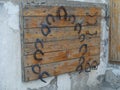 Old rusty horseshoes and stirrups on a wooden background Royalty Free Stock Photo